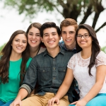 Attractive group of friends embracing