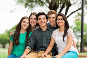 Attractive group of friends embracing