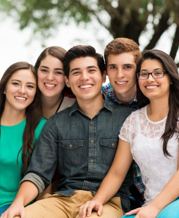 Attractive group of friends embracing