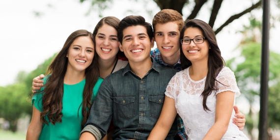 Attractive group of friends embracing
