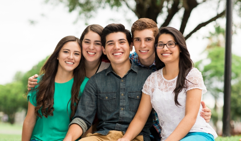 Attractive group of friends embracing